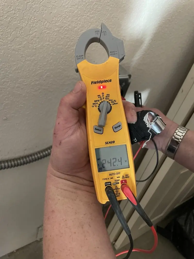 Voltage testing with clamp meter during Outlet Installation in Taylor Creek